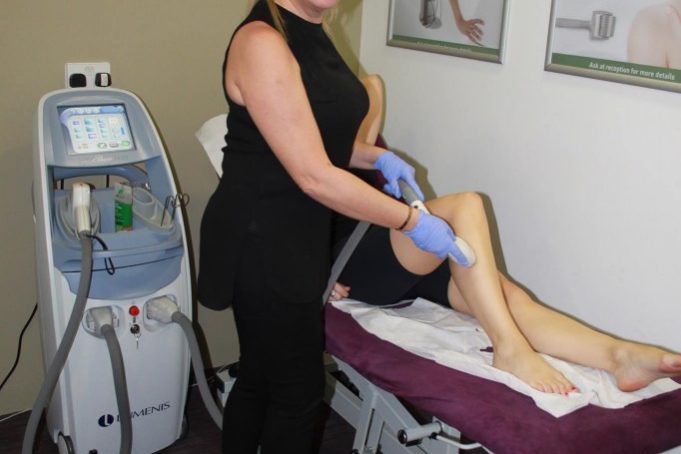 About- Siobhan conducting laser hair removal on a client