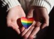 handis hoding a PRIDE coloured heart