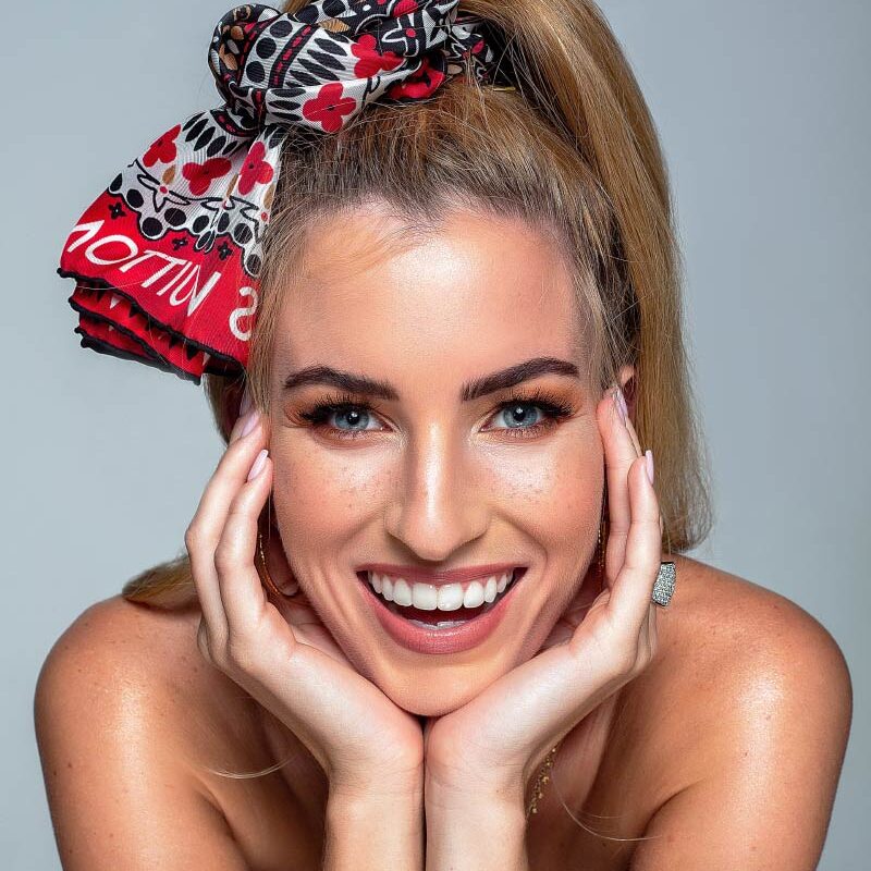 smiling woman with her hands on her face